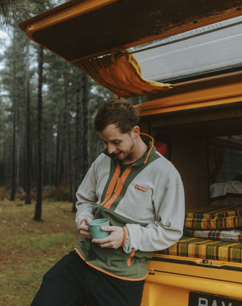 man in columbia sportswear jacket holding mug