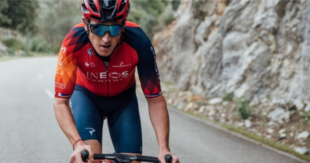 ineos grenadiers cyclist riding a bike wearing sungod sunglasses