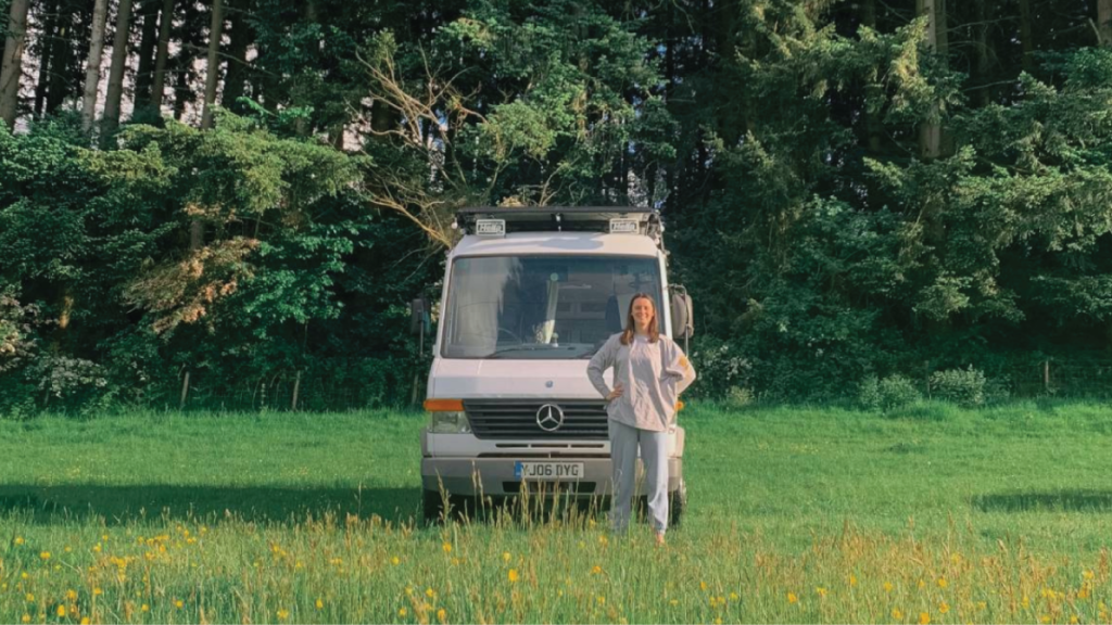 woman standing outside by camper van